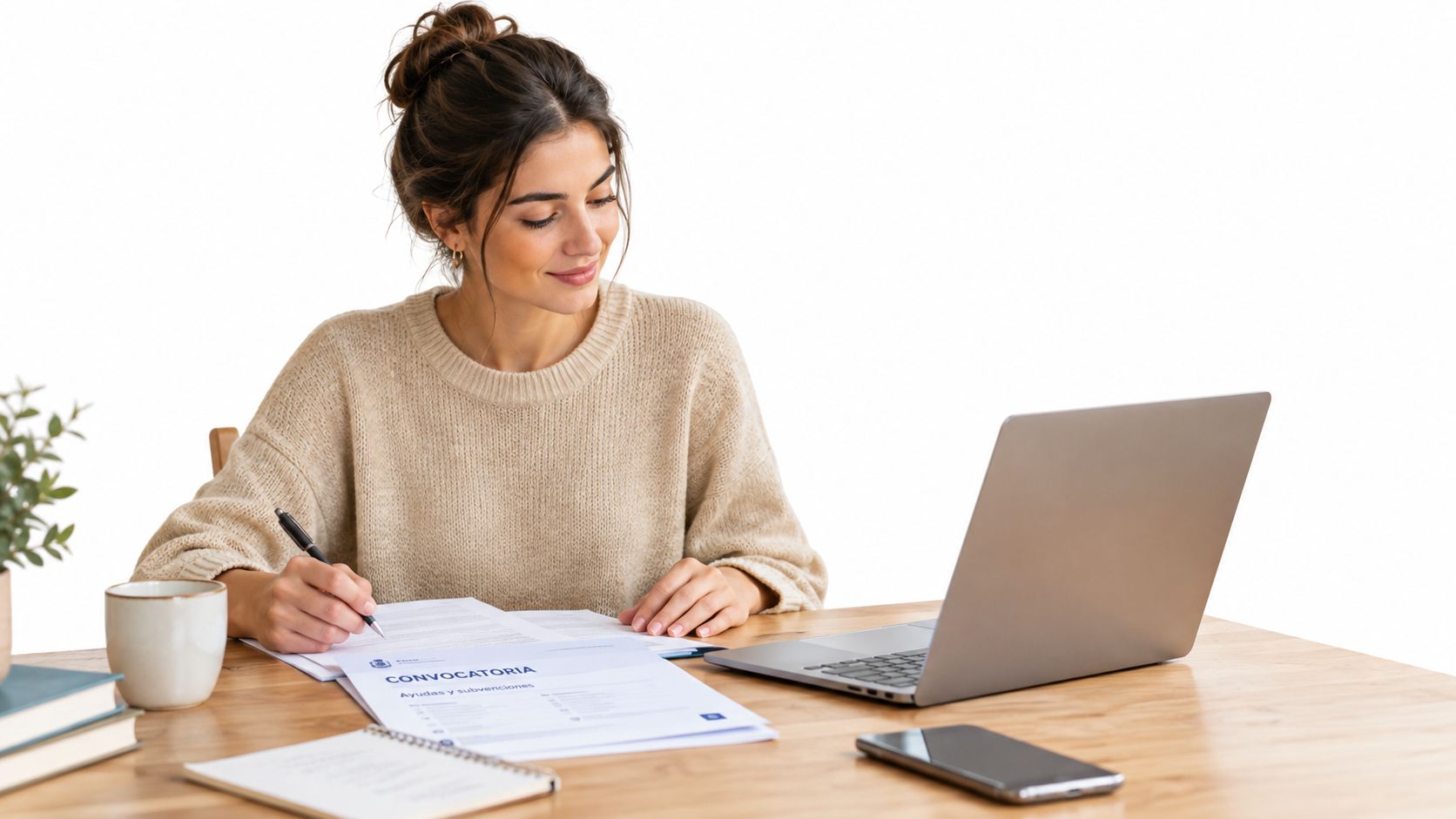 Una mujer joven trabajando en un escritorio revisando formularios de convocatoria para ayudas de vivienda y subvenciones.